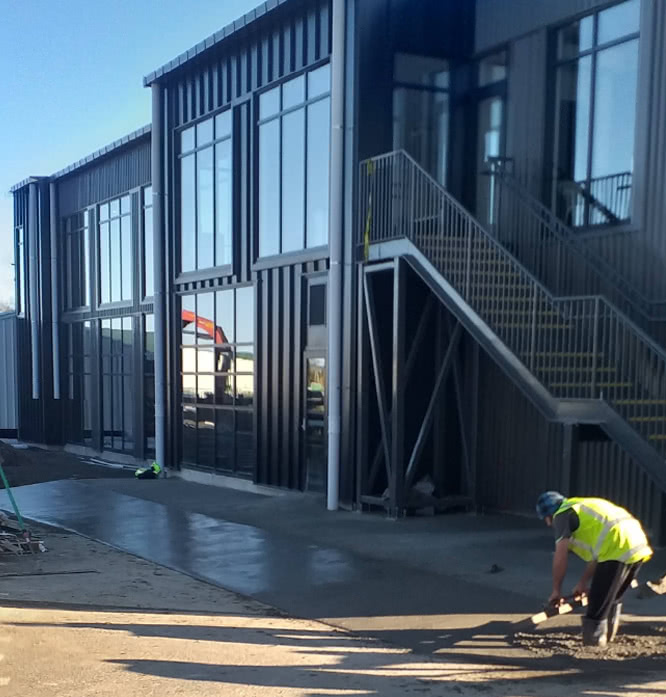 Concrete installer smoothing wet concrete